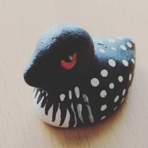 a small wooden bird, painted as a great northern diver (common loon)