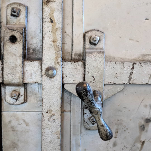 a metal door, scuffed and rusted