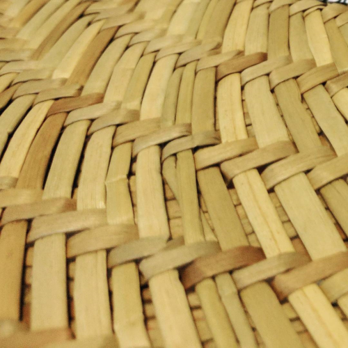 A close-up of the interwoven sections of a straw hat